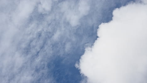 soft white clouds move briskly across a deep blue sky in a dynamic timelapse