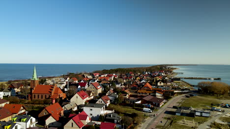 panoramic view of a village near the edge of hel peninsula kuznica poland - ascending aerial drone shot