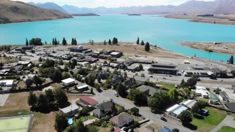 Aerial-wide-shot-of-settlement-on-glacier-lake
