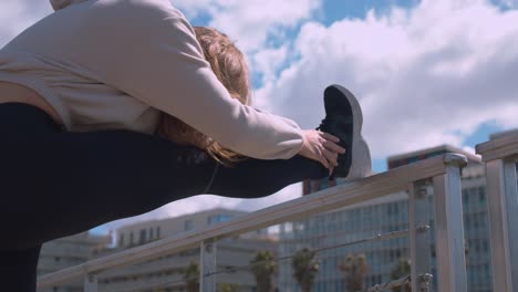 static low angle shot of woman stretching legs outdoors