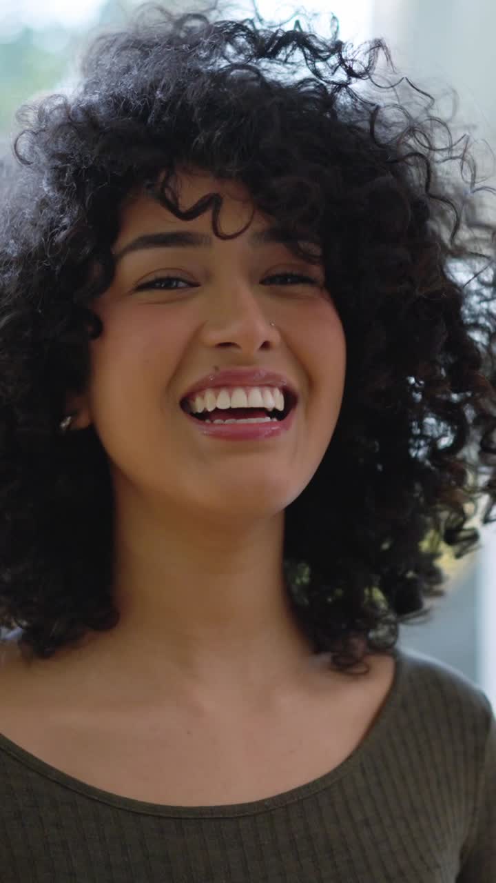 Beauty african woman with curly hair smiling at camera