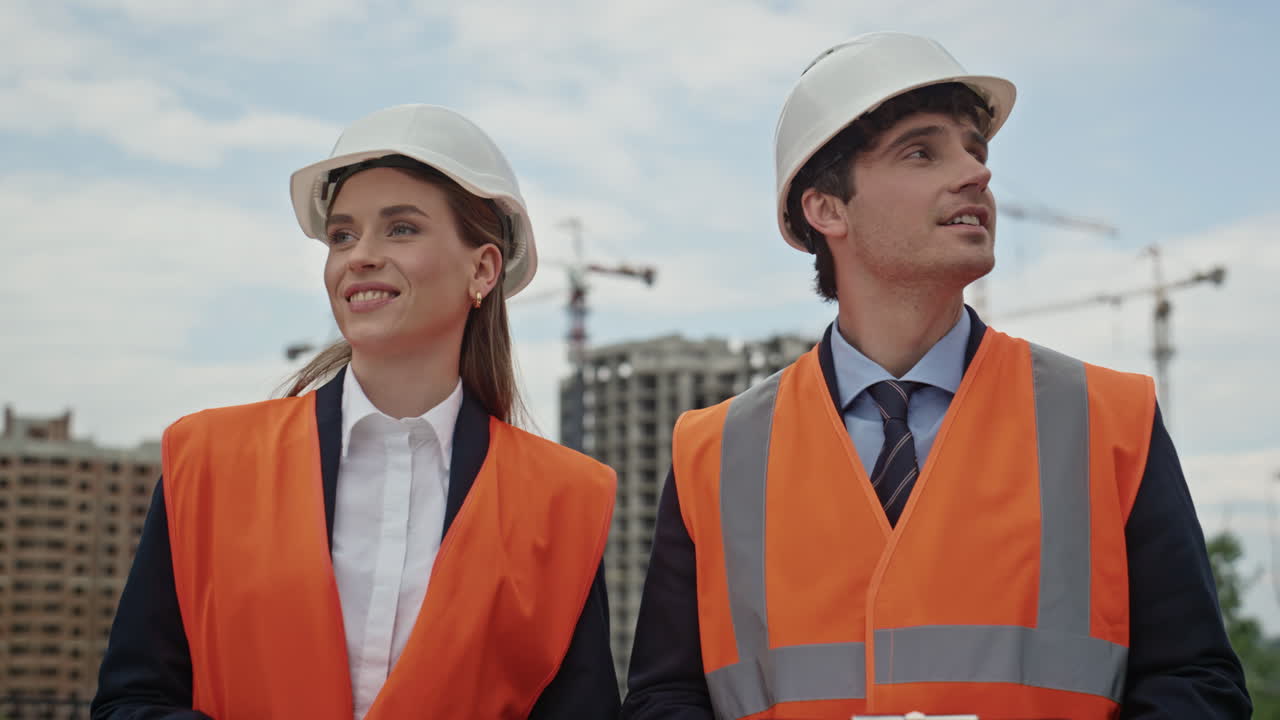 Engineers collaborate building strategy shaking hands at urban worksite closeup