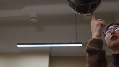 a person indoors with a light fixture