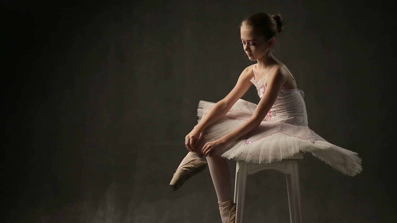 Ballerina In Tutu And Pointe. Little adorable young ballerina in tutu and pointe in the black studio