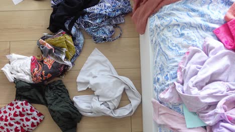 messy clothes on bedroom floor