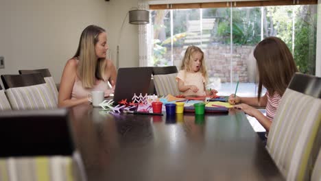 mother and daughters painting together