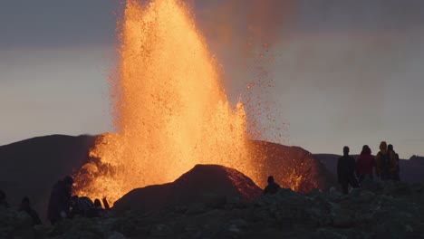 group of spectators watching powerful volcanic eruption iceland 2021