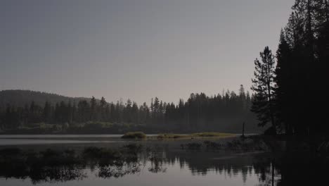 Lake-in-the-morning-with-reflections-as-the-camera-slowly-pans-right