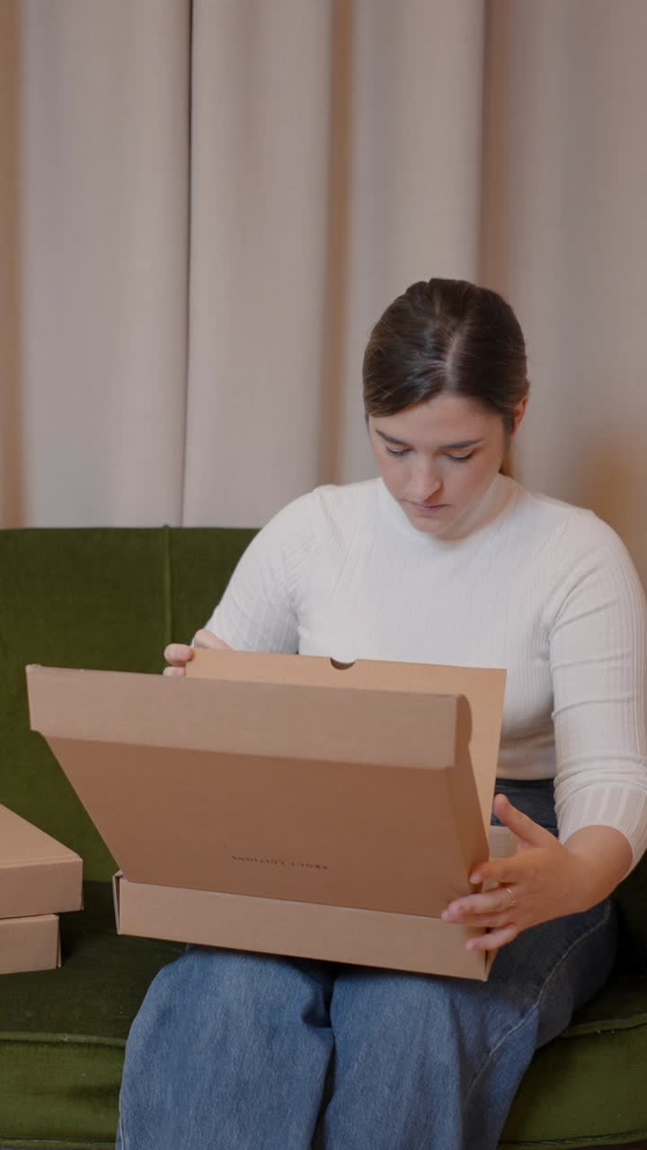 Woman unboxes a package at home