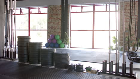 gym equipment like weights and exercise balls are neatly arranged