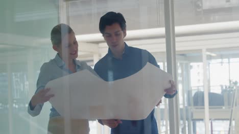 young man and woman working in a creative office