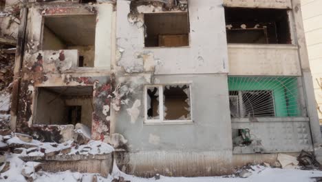 damaged walls and windows in a residential building after the russian military attack