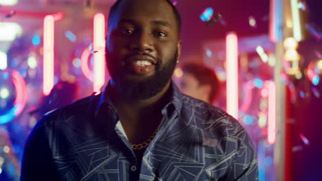 African-american-man-having-rest-in-club.-Afro-guy-looking-at-camera-at-party