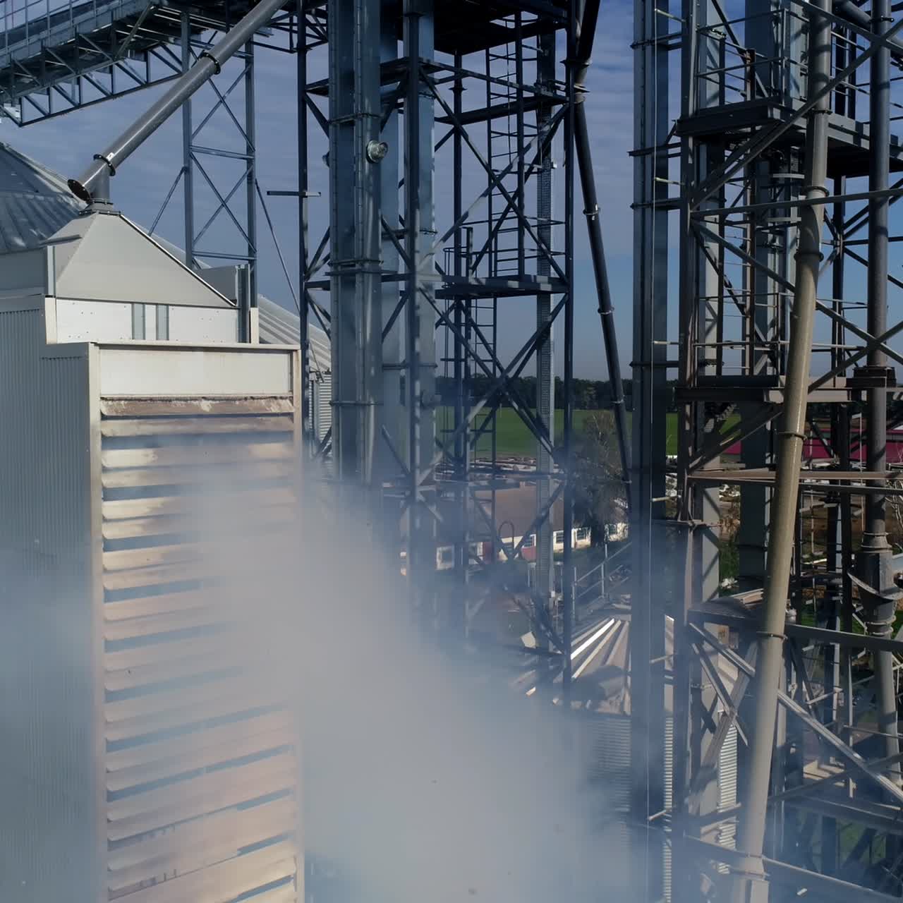 Smoke from industrial plant. Modern grain elevators from the air. Agricultural manufacturing pollutes the atmosphere. Aerial view