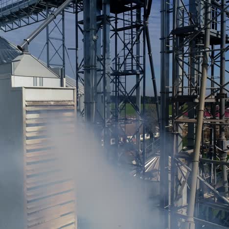Smoke from industrial plant. Modern grain elevators from the air. Agricultural manufacturing pollutes the atmosphere. Aerial view