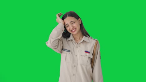 Stressed-Indian-female-police-officer-removing-hat-Green-screen