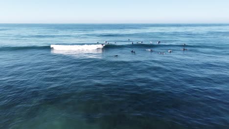 surfers in carlsbad on a sunny morning