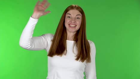 woman smiling and gesturing on green screen