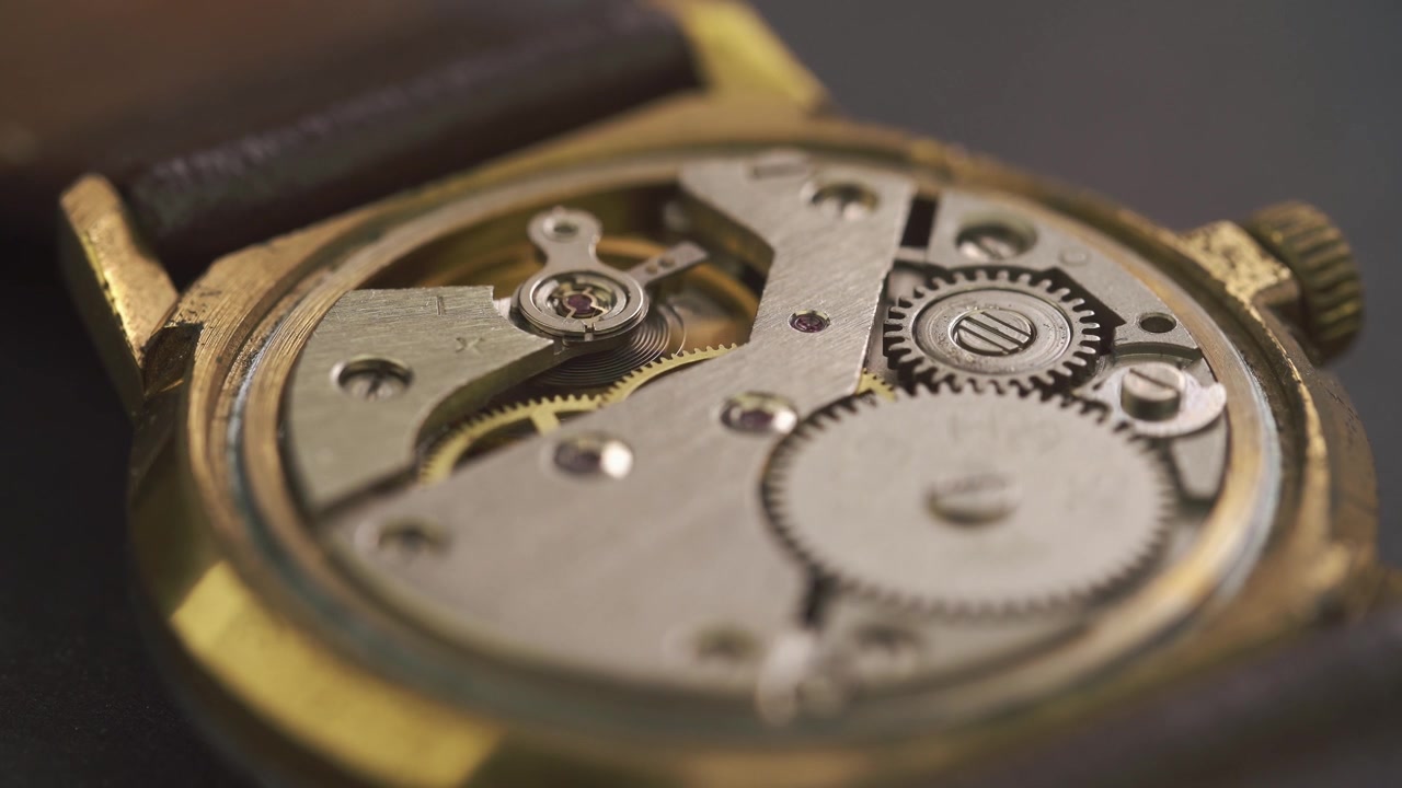 Close-up of Intricate Mechanical Gears Working Inside a Vintage Watch