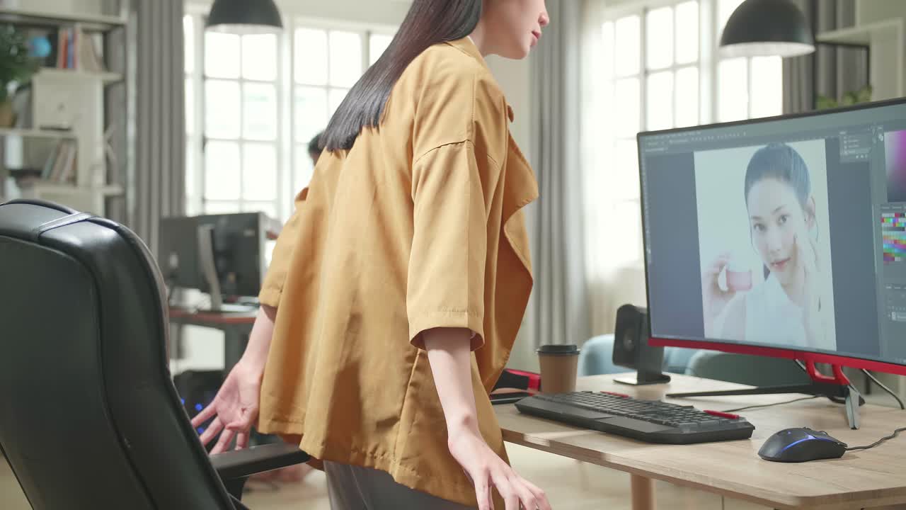Asian Female Digital Editor Start Works In Photo Editing Software On Her Personal Computer With Big Display In Office