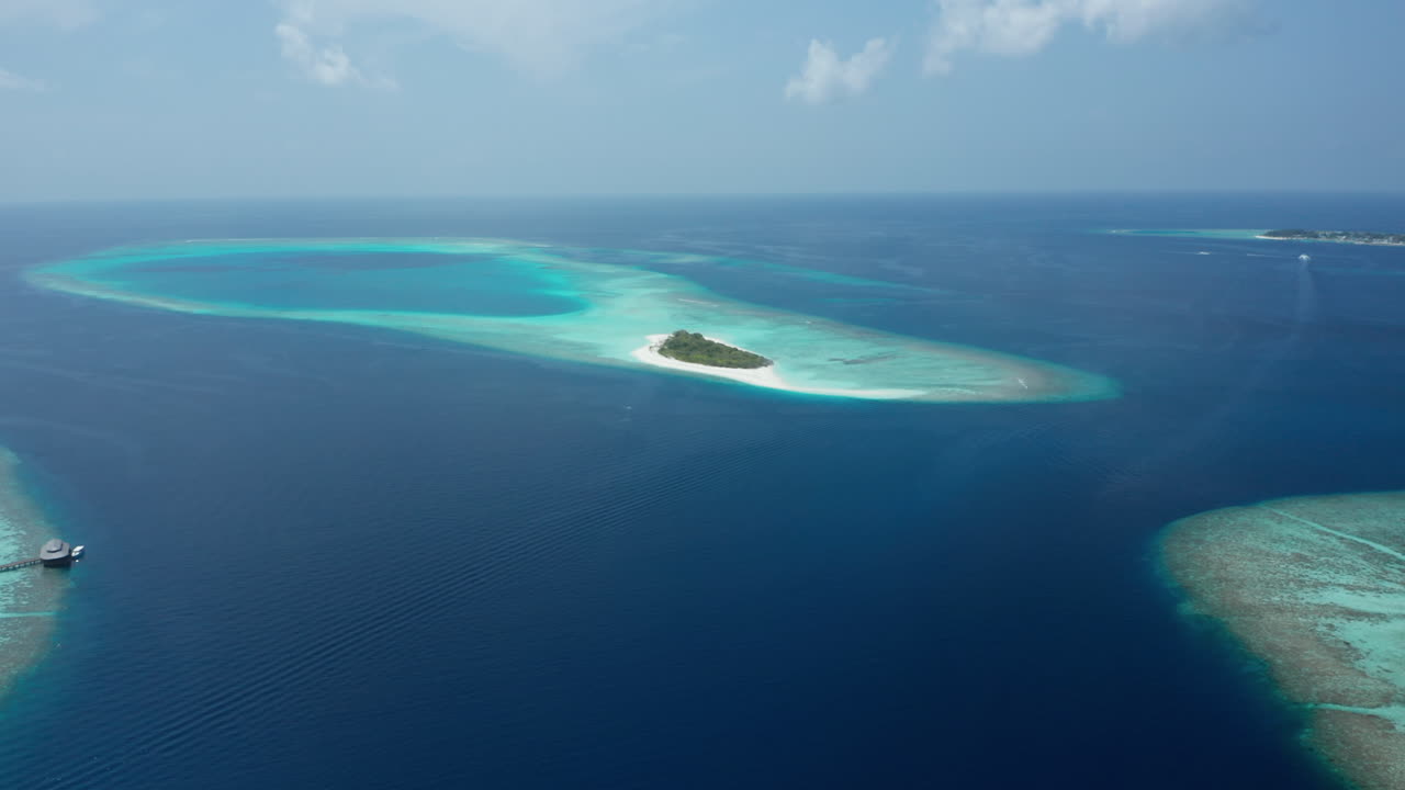 Aerial view Private island Hanifarurah surrounded with tropical blue water in the Maldives