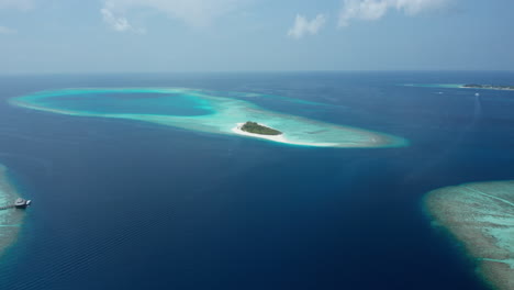 aerial view private island hanifarurah surrounded with tropical blue water in the maldives
