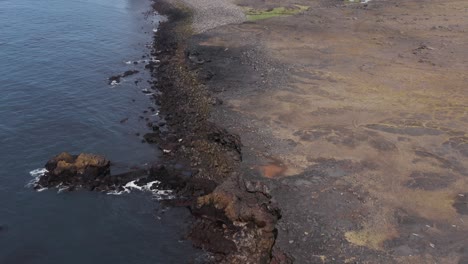 Costa-Salvaje-De-Islandia-Con-Campo-De-Lava-Sólida-Con-Agua-Del-Océano-Atlántico