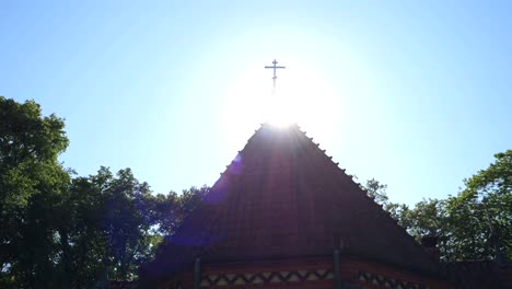 cross on the church roof in full sunlight