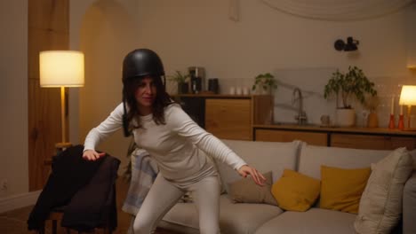 woman dancing in a living room with a helmet