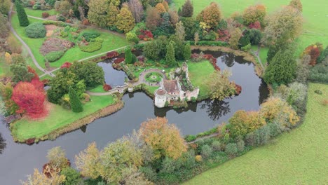 aerial view of a castle ruin on an island in a lake during autumn