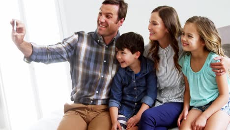 Happy-family-taking-a-selfie-on-mobile-phone