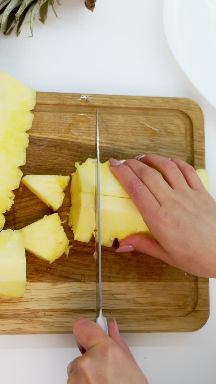 View of slices of fresh pineapple. Sliced pineapple on desk with knife isolated on white background