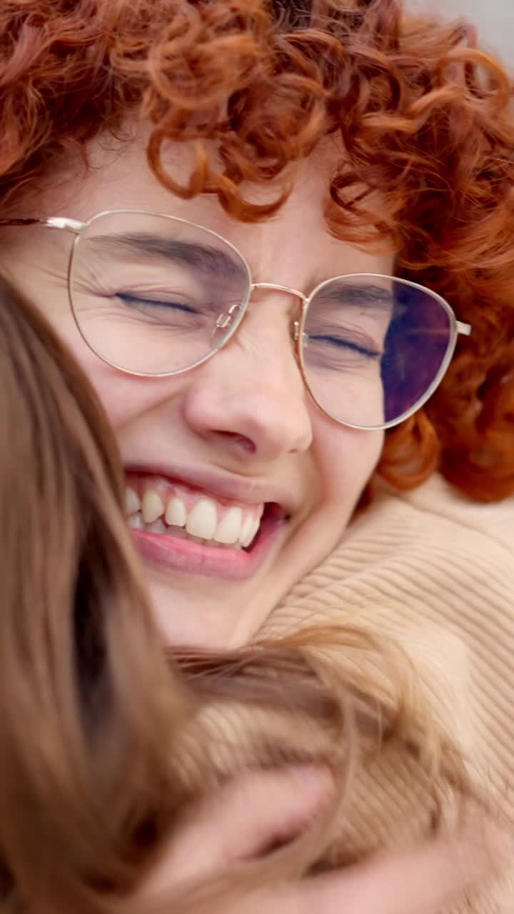 Happy meeting between two young friends in the street