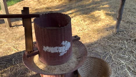 manual rice milling process in rural thailand