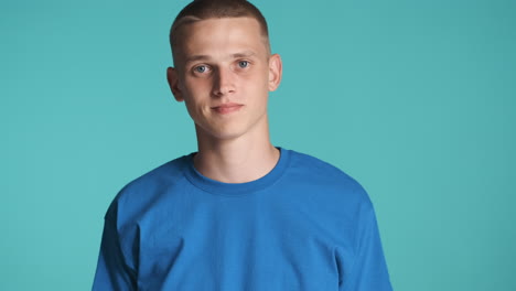 Doubtful-boy-in-blue-clothing-posing