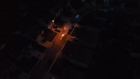 Group-of-people-lighting-off-fireworks-viewed-from-the-air