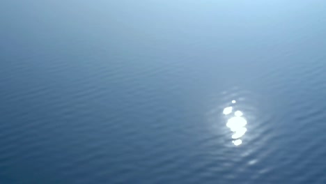 abstract beautiful blurred of sun glare sparkling on water surface background