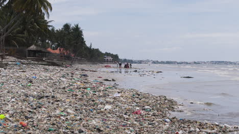 group of people cleaning the beach after a big storm on ham tien beach in vietnam