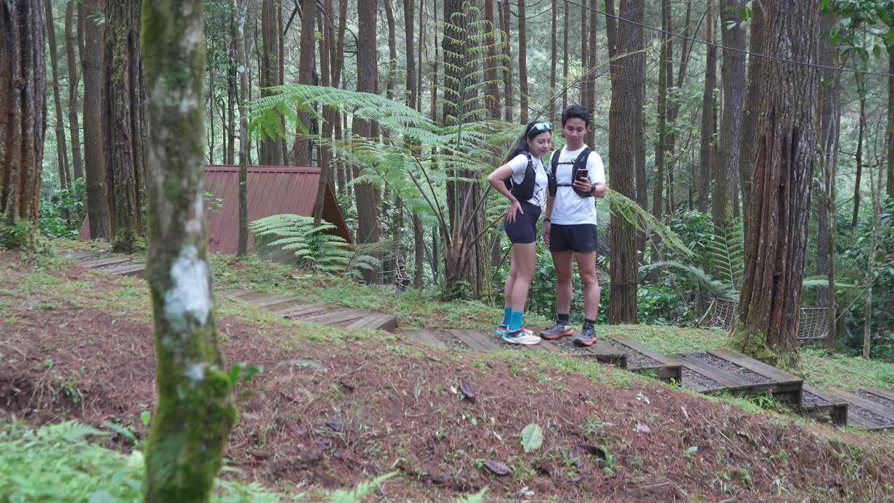 Indonesian young adults using smartphone during trail run in forest