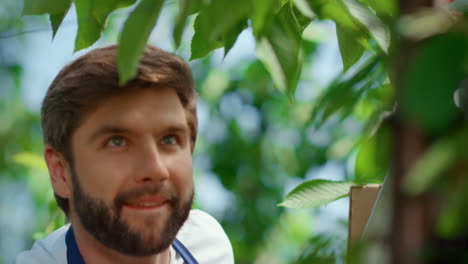 Happy-farmer-harvesting-cherry-tree-on-farm-portrait.-Agribusiness-concept