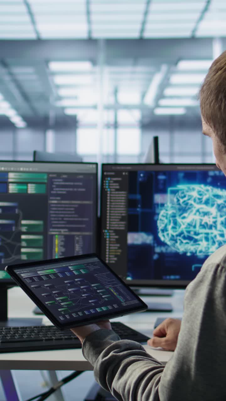 Programmer Working with Code on Tablet and Computer Screens in Modern Office