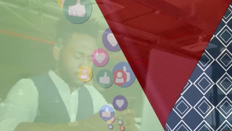 Animation-of-social-media-icons-over-african-american-businessman-using-smartphone-at-a-cafe