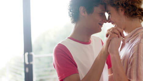 Happy-diverse-gay-male-dancing-and-smiling-at-home,-slow-motion