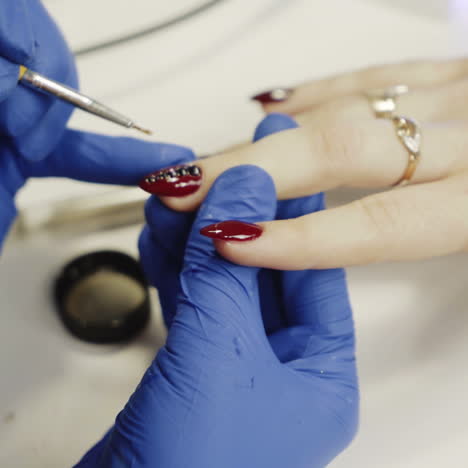 manicure concept. girl paint nails in the salon of manicure, close-up square video