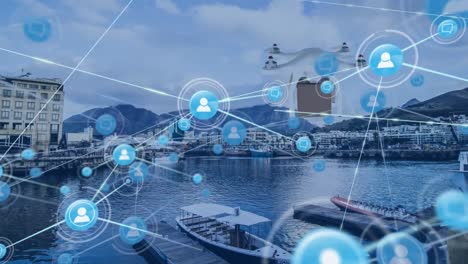red de iconos digitales y un avión no tripulado que lleva una caja de entrega contra una vista aérea del puerto