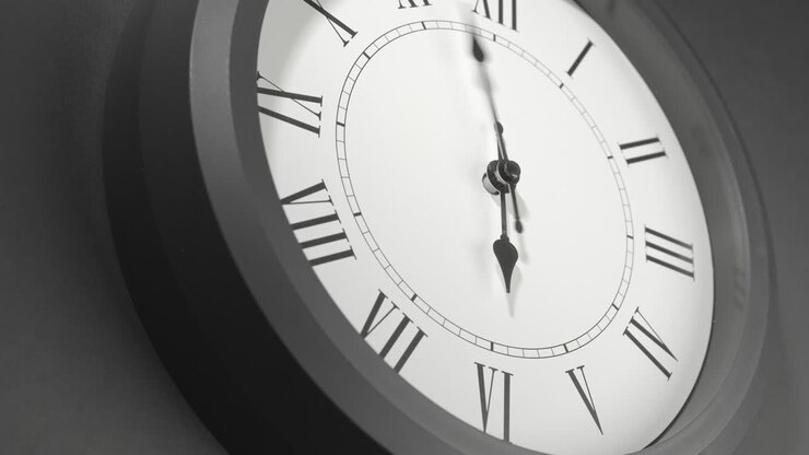 Latin Clock Face in Time Lapse on Dark Grey Wall