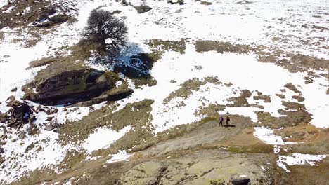 toma de drones de excursionistas caminando en una montaña cubierta de nieve