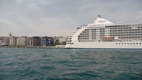 cruise ship docked in a city harbor