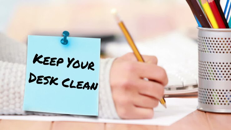 Animation of keep your desk clean text over hand of caucasian student writing in notebook