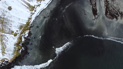 aerial view of beautiful beach with waves and water crashing on to sandy shore from top angle